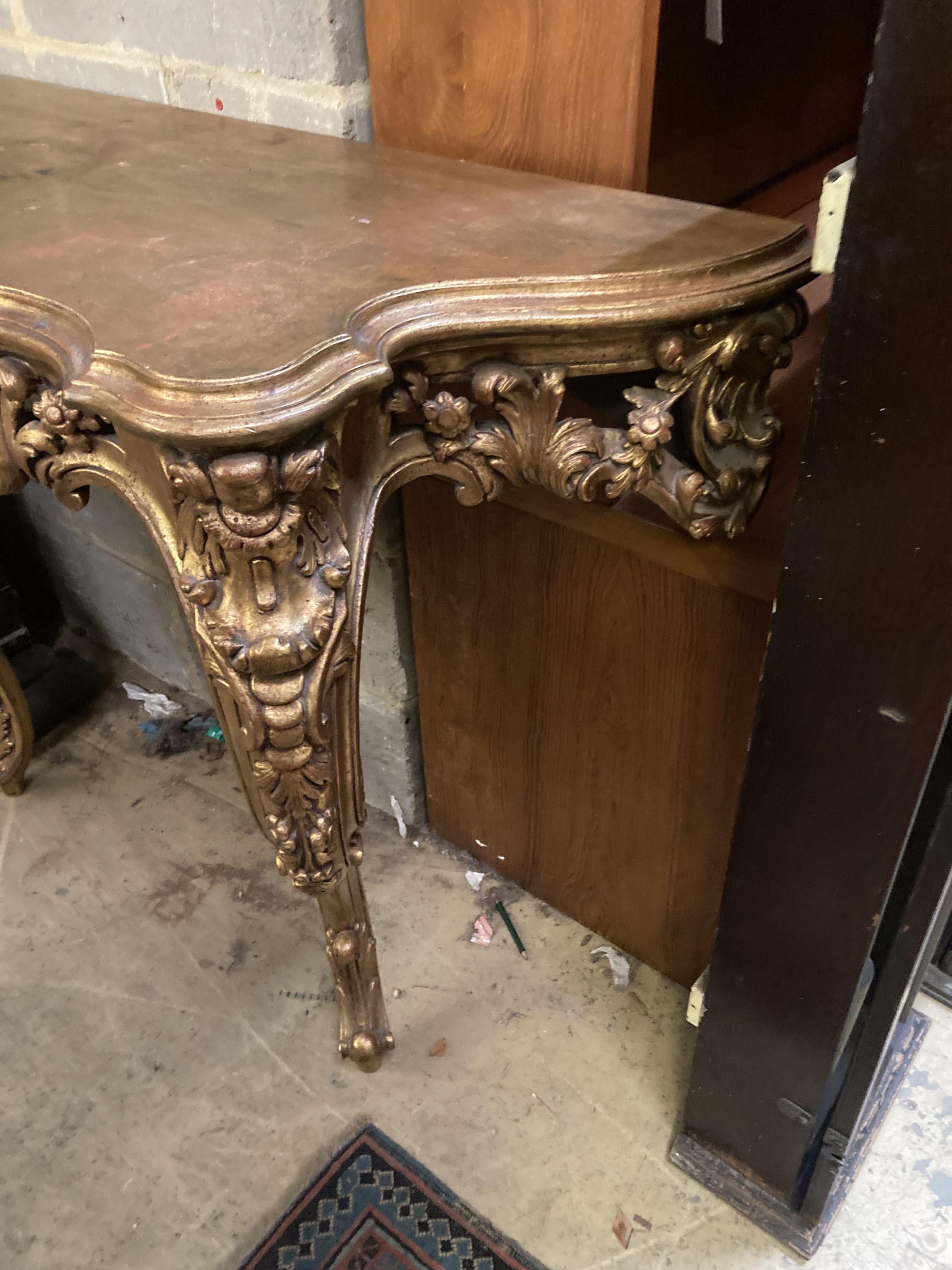 A Louis XV style carved giltwood serpentine console table, width 120cm, depth 50cm, height 89cm